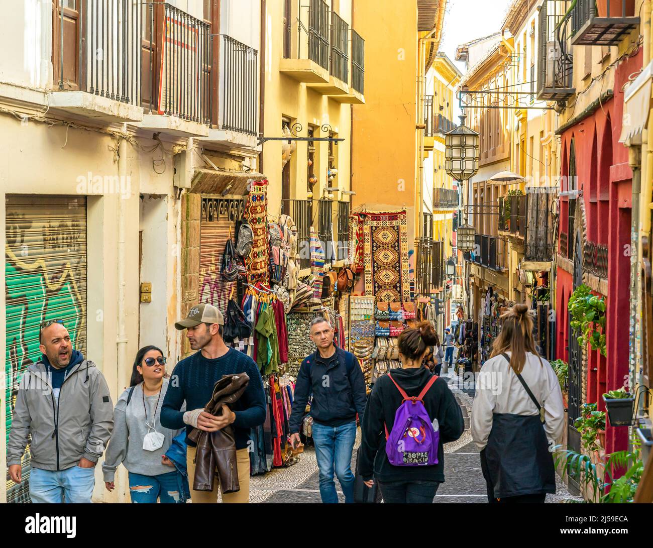 Calle Calderería Nueva -  narrow alleyway, busy little street with shops businesses offering traditional authentic goods and crafts. Granada, Spain Stock Photo