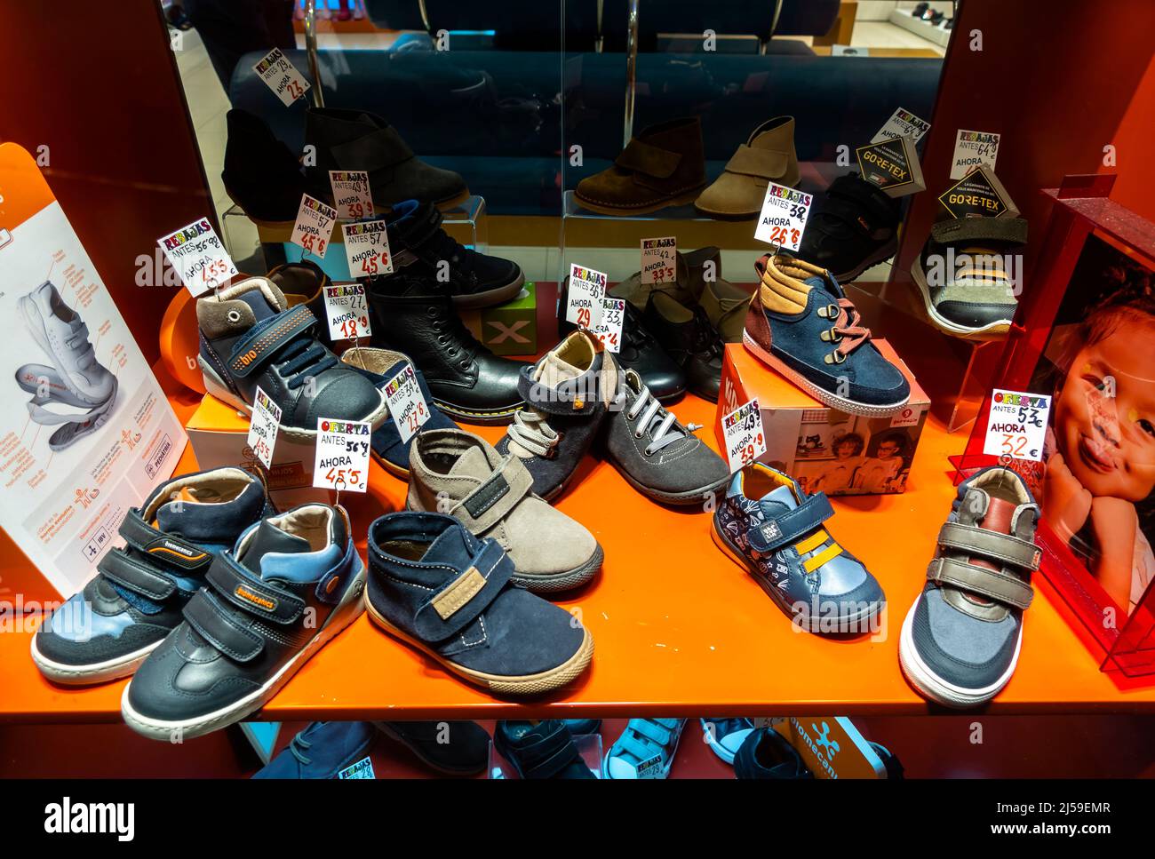 Sales shoes footwear mens shoes sports on display in Nico shop window, Granada, Andalucia, Spain Stock Photo