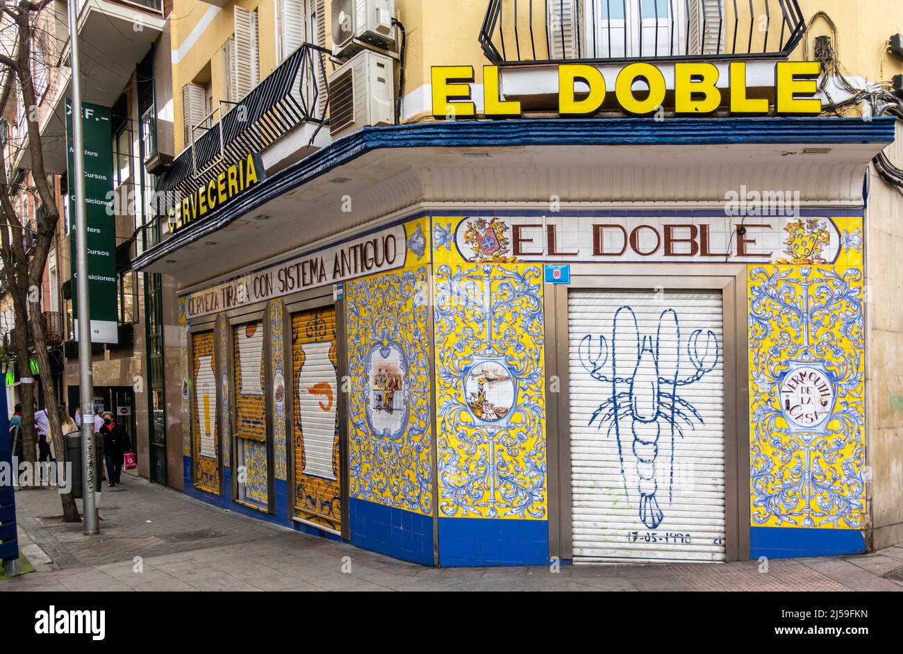 Cerveceria El Doble, Madrid: Boarded up colorful seafood graffiti on the wall doors of the closed restaurant in central Madrid, Spain. Stock Photo