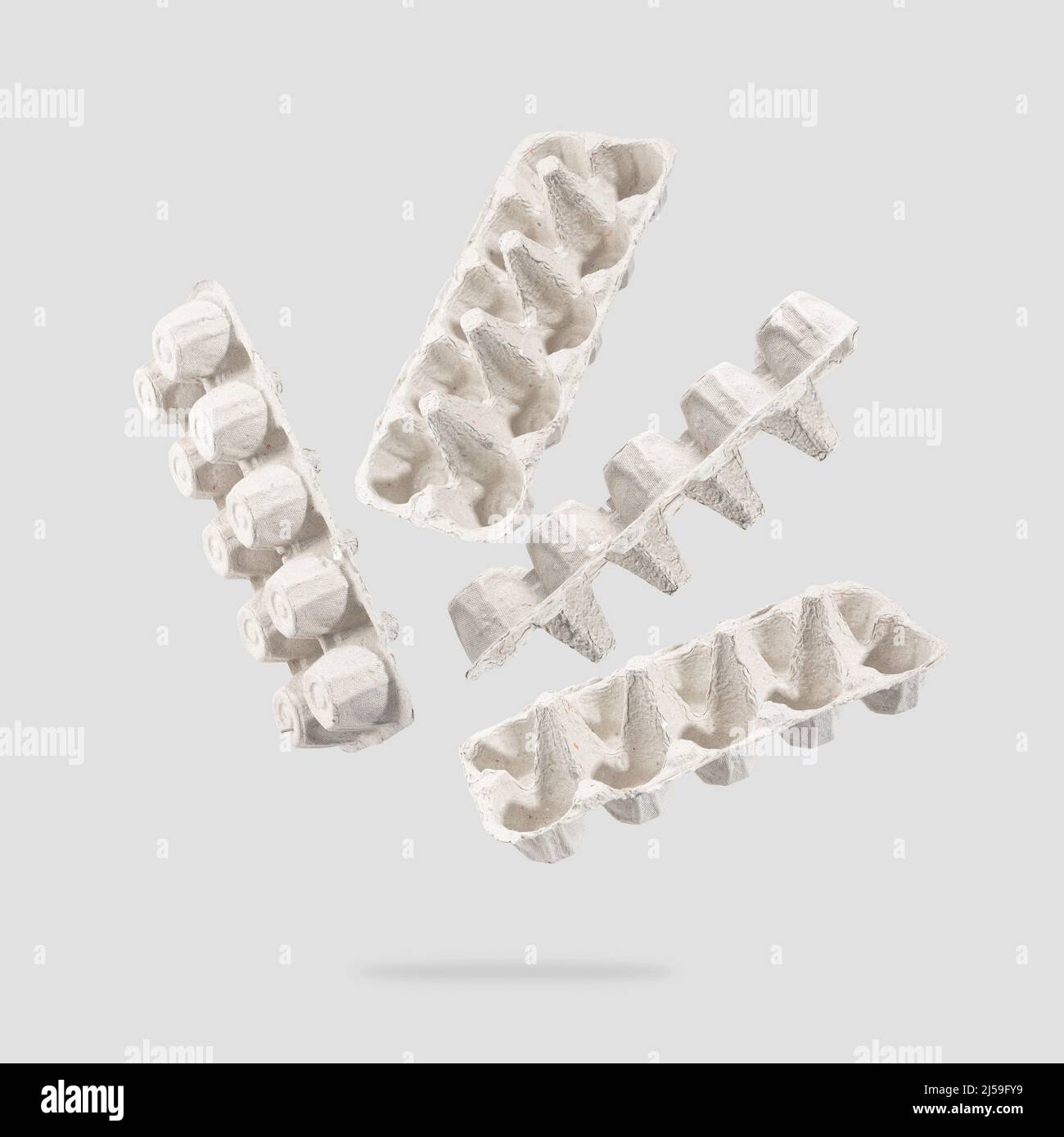 An egg carton made of recycled cardboard on a gray background. An egg