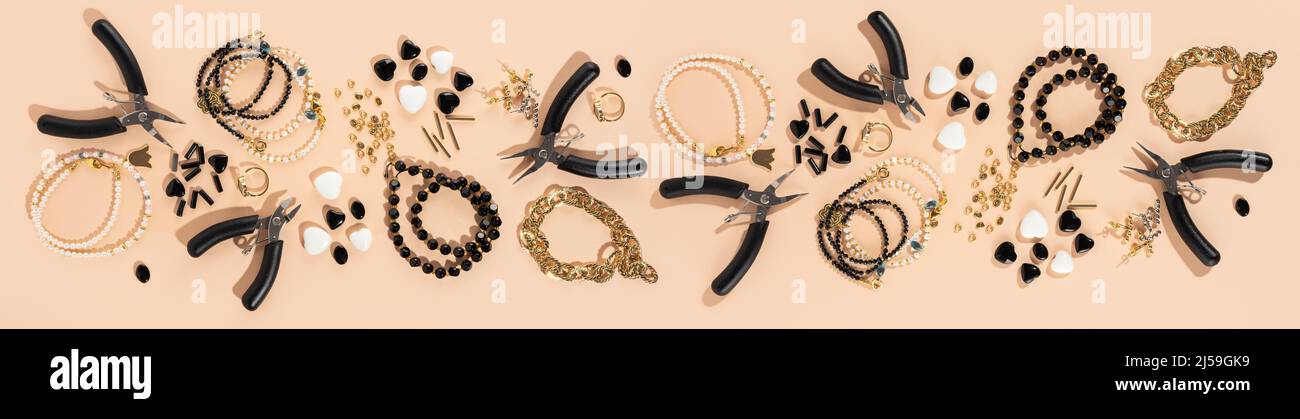 Tools and accessories for DIY jewelry in the workplace. Flat lay on beige background. Creative flat lay, panoramic composition, extra wide banner, Stock Photo