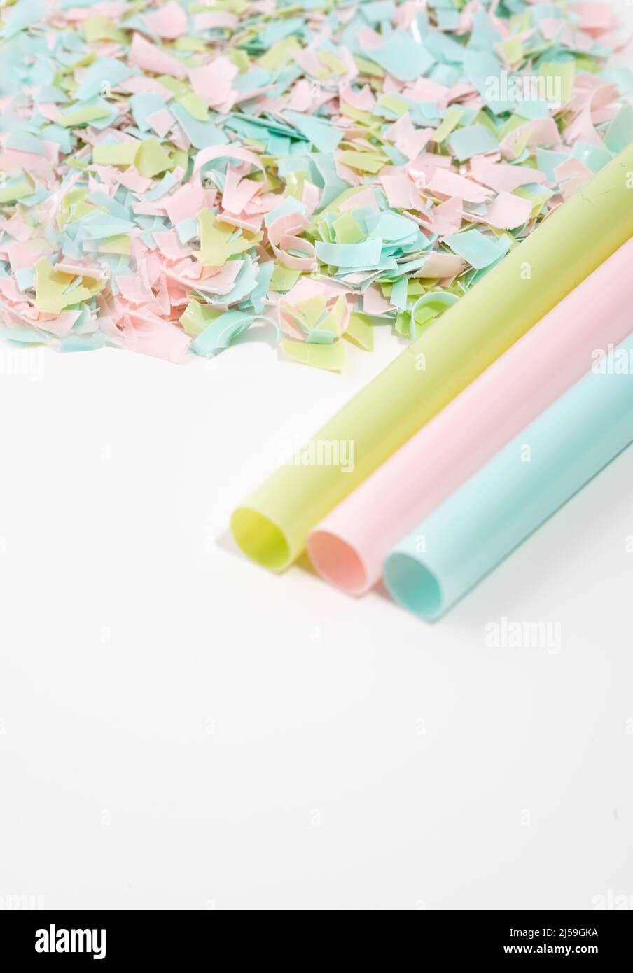 Drinking straws and microplastics on a white background. Impact of micro plastic on the food chain. Concept of environmental damage. Stock Photo
