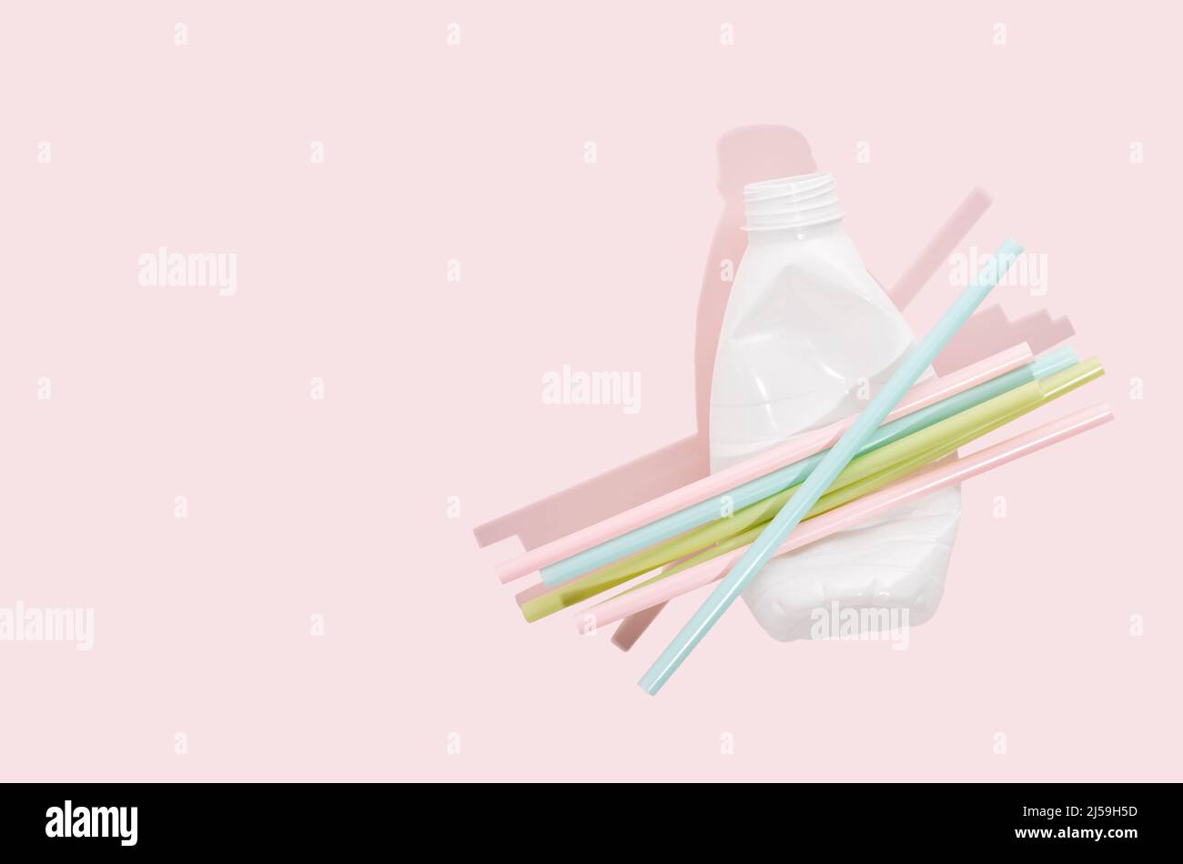 Negative impact on nature. Plastic bottles, straws on a minimalistic