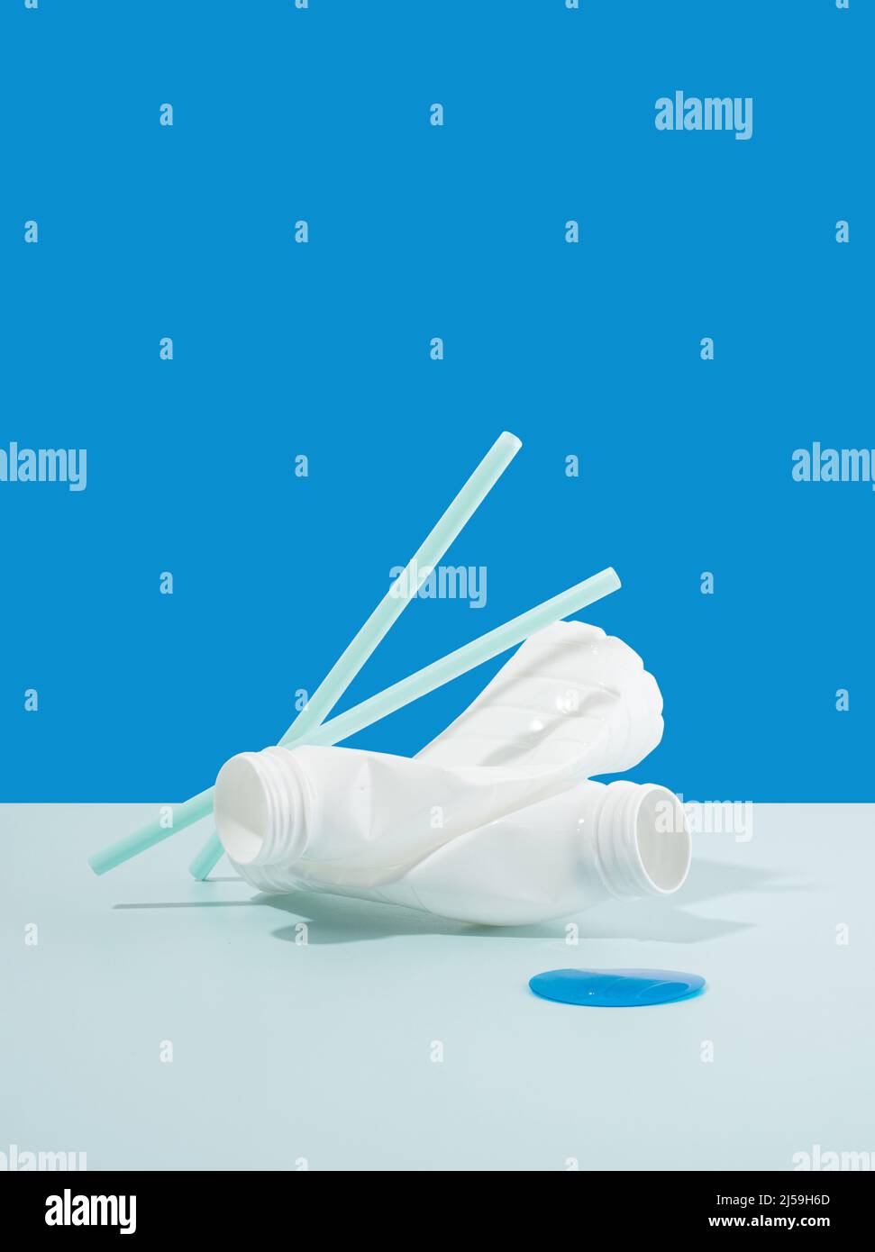 Negative impact on nature. Plastic bottles, straws on a minimalistic