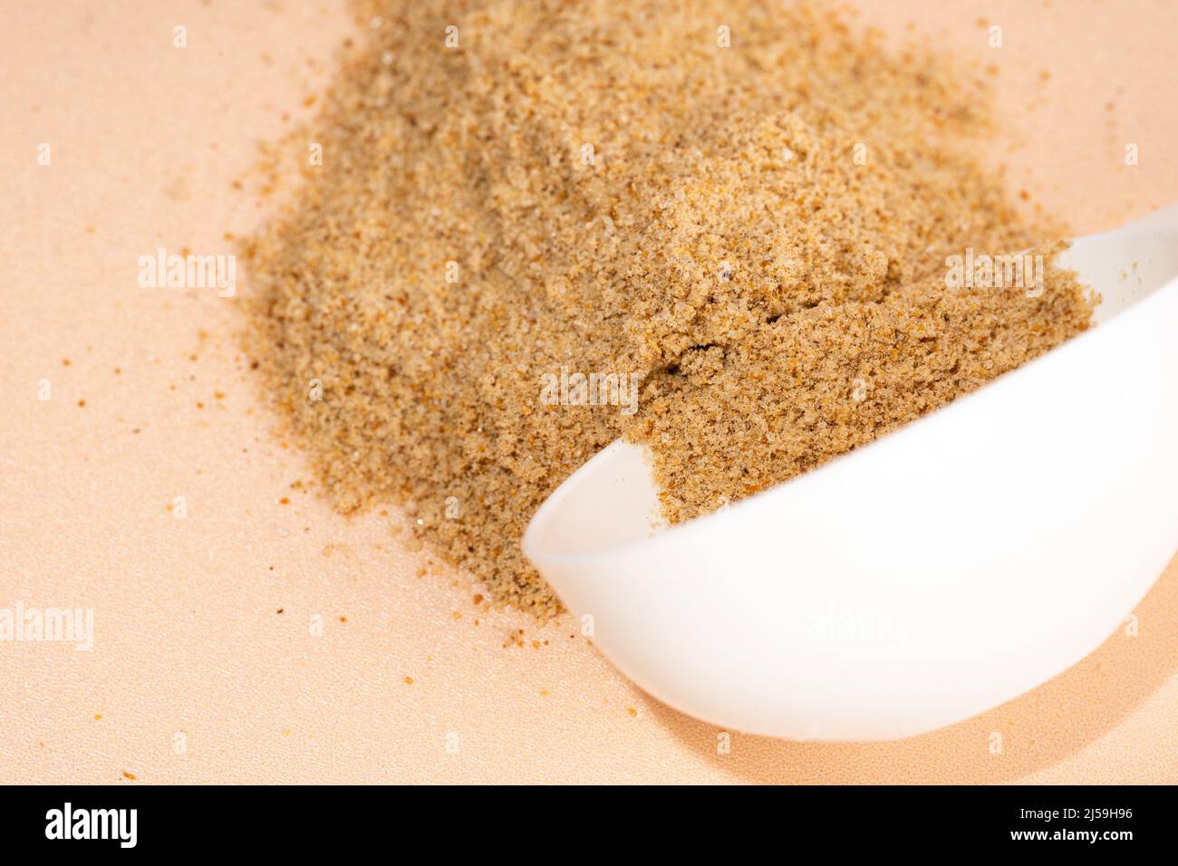Mixture of dietary supplements. White can of dietary fiber and scoop on a beige background. Dietary herbal supplements, biologically active additives Stock Photo