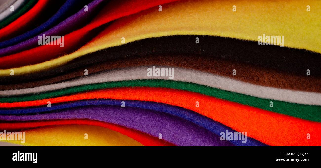 Several colored felt texture background. Assorted color felt fabric sheets, patchwork, sewing DIY craft Stock Photo