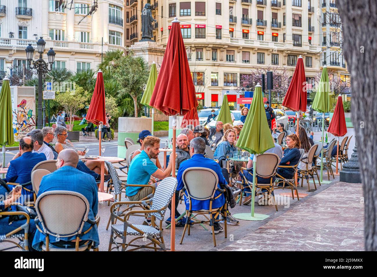 Tourists or group of people sitting on a restaurant patio in the Plaza del Ayuntamiento or City Hall Town Square. Located in the old town, this reside Stock Photo