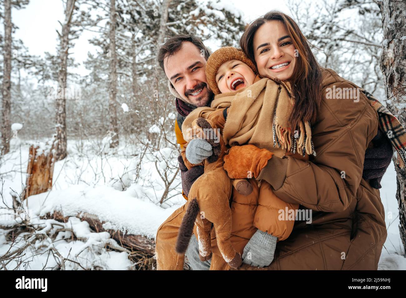 Portrait of happy family in winter clothes in forest Stock Photo - Alamy