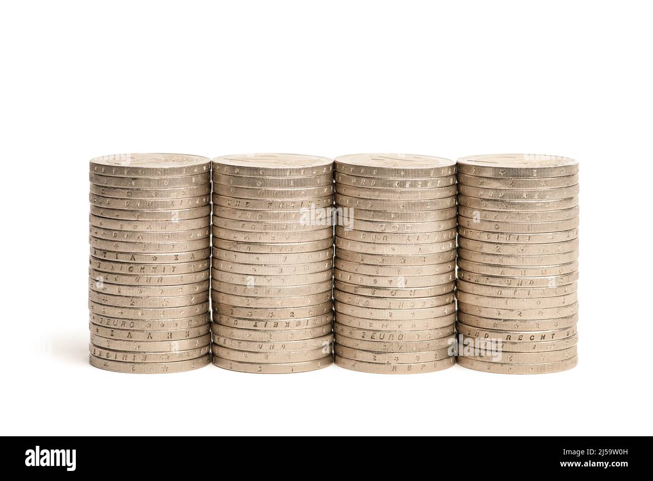 Stacks of coins on a white isolated background. 2 euro coins in a stack ...