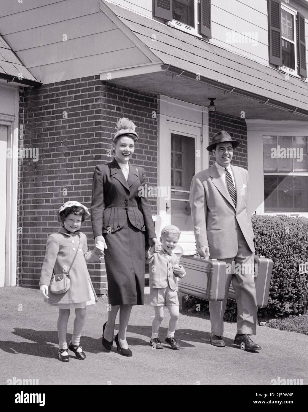 https://c8.alamy.com/comp/2J59W4F/1950s-family-of-four-walking-down-driveway-of-house-father-holding-luggage-mother-holding-hands-of-the-son-and-daughter-j1092-har001-hars-luggage-clothing-nostalgic-pair-4-community-suburban-mothers-old-time-nostalgia-brother-old-fashion-sister-driveway-juvenile-style-young-adult-fashionable-sons-joy-lifestyle-females-houses-married-brothers-spouse-husbands-healthiness-home-life-copy-space-friendship-full-length-ladies-daughters-persons-residential-males-buildings-siblings-sisters-fathers-bw-partner-suit-and-tie-happiness-dads-excitement-pride-homes-sibling-connection-residence-stylish-2J59W4F.jpg