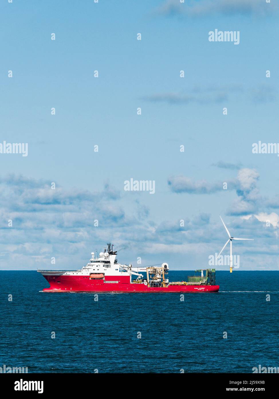 Global Symphony multi-purpose support vessel and offshore wind turbines off the Northumberland coast, UK with copy space. Stock Photo