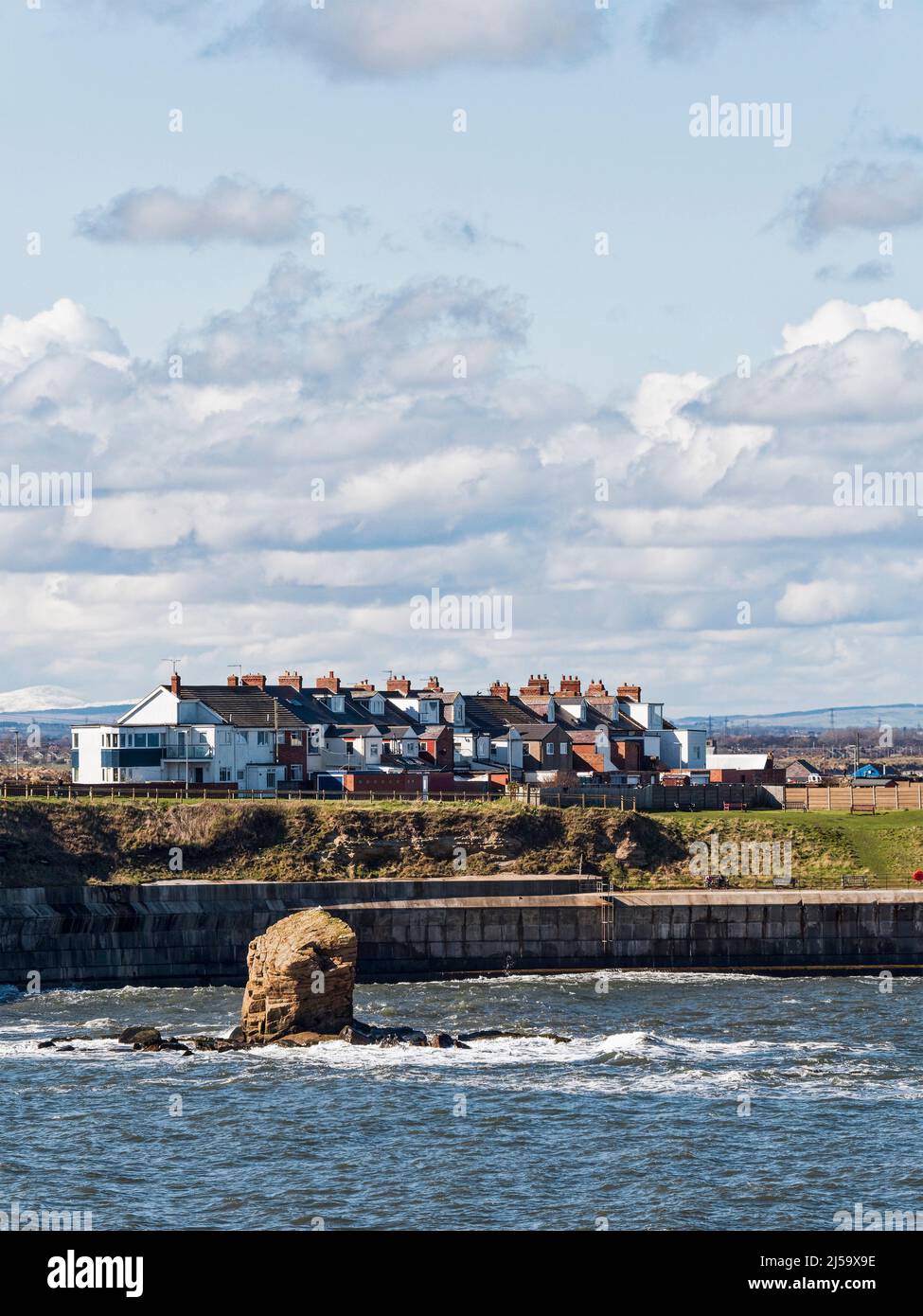 Coastal village of Seaton Sluice in Northumberland, UK with sandstone rock formation known as Charlie's Garden, UK. Stock Photo