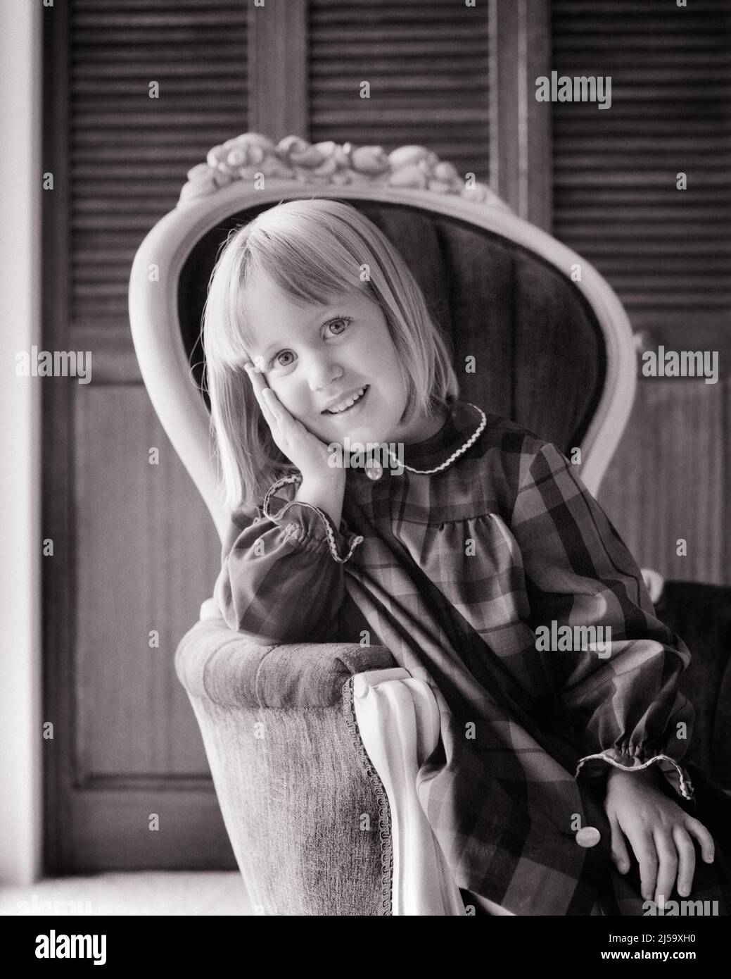1960s PORTRAIT OF SMILING BLONDE GIRL RESTING HER HEAD IN HER HAND LOOKING AT CAMERA SITTING IN FRENCH PROVINCIAL CHAIR - j13592 HAR001 HARS LIFESTYLE FEMALES WINNING STUDIO SHOT HOME LIFE COPY SPACE HALF-LENGTH CONFIDENCE EXPRESSIONS B&W RESTING EYE CONTACT HAPPINESS BRIGHT CHEERFUL PRIDE SMILES CONCEPTUAL JOYFUL PROVINCIAL STYLISH CHARMING GROWTH JUVENILES BLACK AND WHITE CAUCASIAN ETHNICITY HAR001 OLD FASHIONED Stock Photo