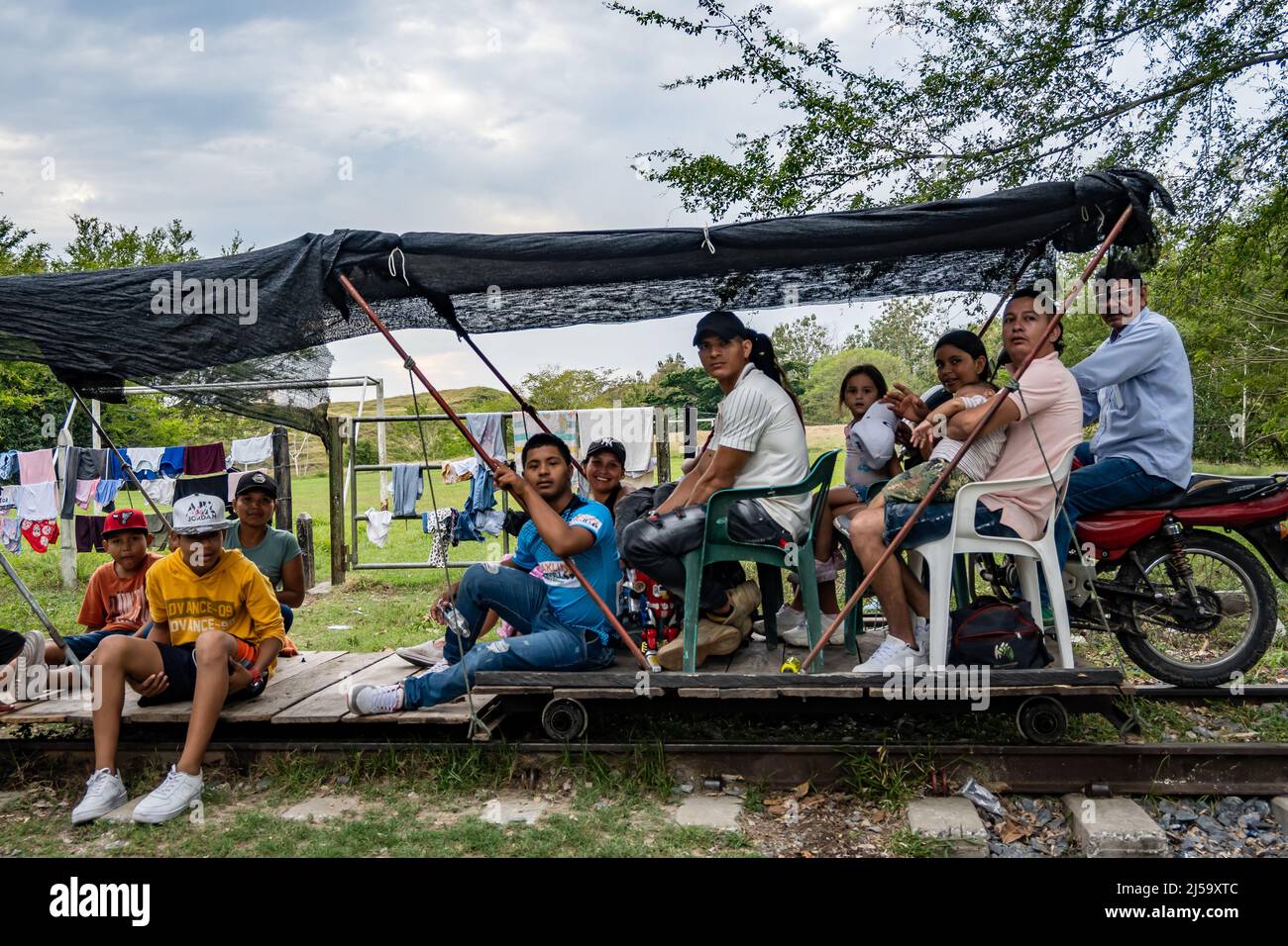 Brujita, a wooden cart driven by a motorcycle, transports passengers on rail road track. Colombia, South America. Stock Photo