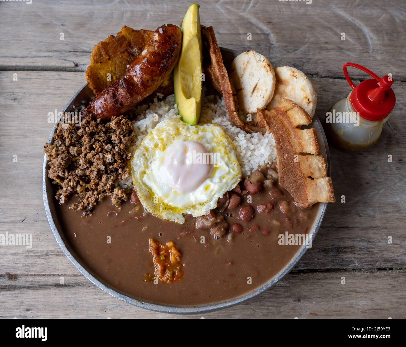 Bandeja paisa, a typical Colombian dish with rice, beans, plantain, chorizo, meat and a fried egg. Colombia, South America. Stock Photo