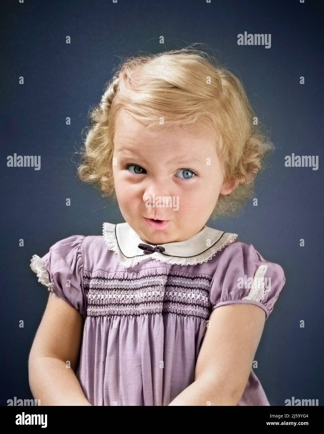 1930s 1940s BLOND TODDLER GIRL LOOKING AT CAMERA UP AND TO THE SIDE SHY BASHFUL FACIAL EXPRESSION WEARING DRESS WITH SMOCKING - j3100c HAR001 HARS STUDIO SHOT HOME LIFE COPY SPACE HALF-LENGTH EXPRESSIONS EYE CONTACT HAPPINESS DISCOVERY AND THE TO UP SHY PLEASANT AGREEABLE CHARMING JUVENILES LOVABLE PLEASING ADORABLE APPEALING BABY GIRL BASHFUL CAUCASIAN ETHNICITY HAR001 OLD FASHIONED SMOCKING Stock Photo