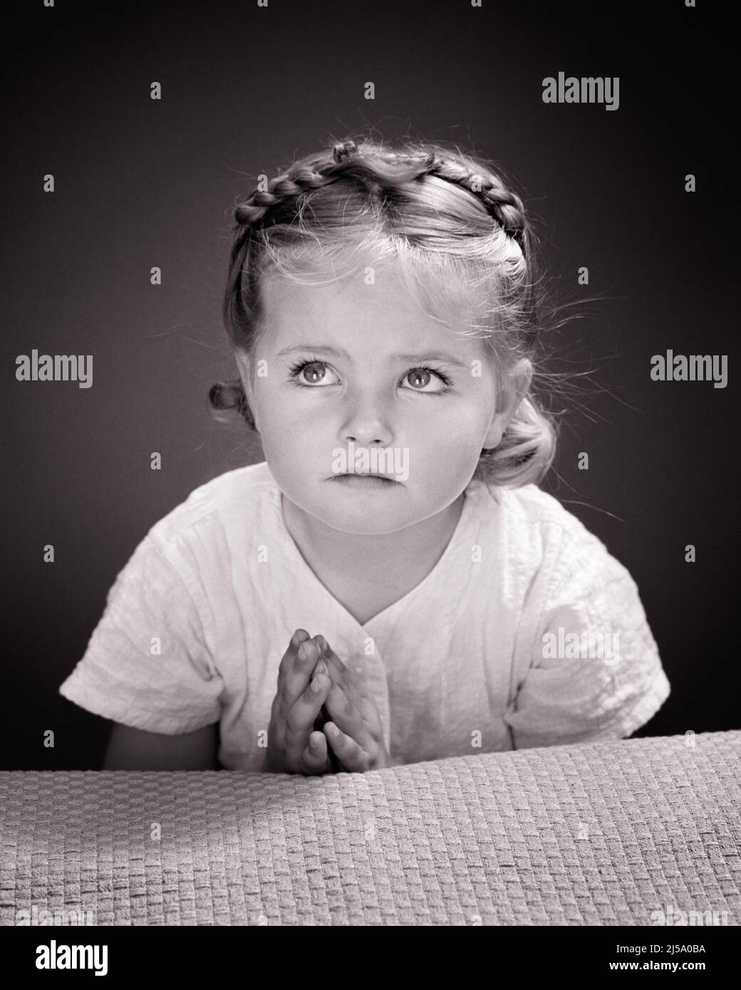 1940s LITTLE GIRL HANDS CLASPED LOOKING UP SERIOUS EXPRESSION SAYING HER BEDTIME PRAYERS - j9347 HAR001 HARS STRENGTH POWERFUL PRAY UP CLASPED PRAYERS SINCERE FAITHFUL SOLEMN FAITH FOCUSED INTENSE JUVENILES NIGHTTIME BELIEF BLACK AND WHITE CAREFUL CAUCASIAN ETHNICITY EARNEST HAR001 INTENT OLD FASHIONED Stock Photo