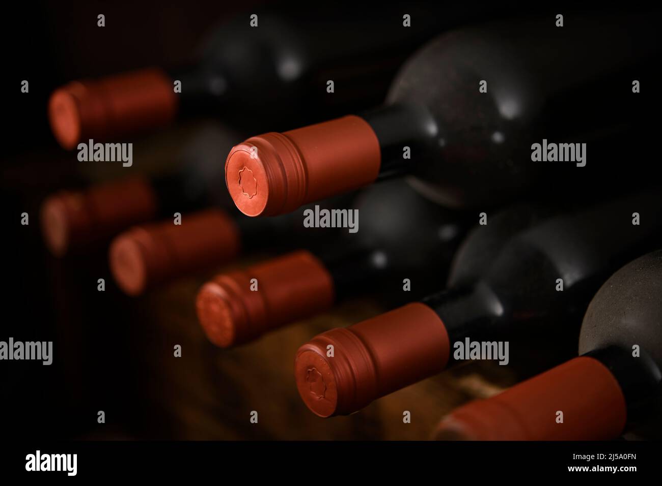 Red wine bottled in the aging process Stock Photo