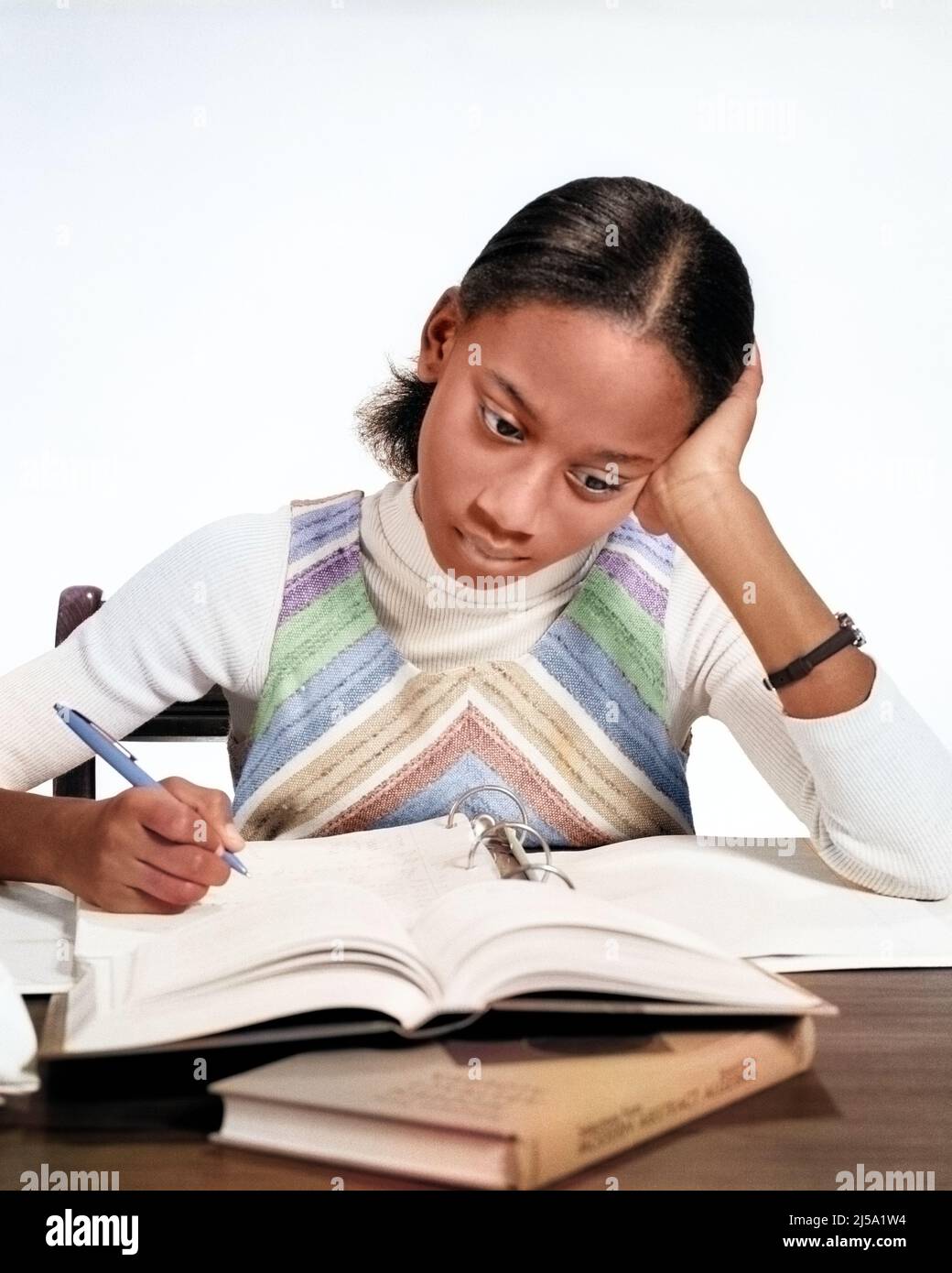 1970s AFRICAN-AMERICAN TEEN GIRL STUDYING MAKING NOTES OPEN BOOK AND NOTEBOOK DOING HOMEWORK - s20840c HAR001 HARS LIFESTYLE SATISFACTION FEMALES HOME LIFE COPY SPACE PERSONS DOING CARING TEENAGE GIRL GOALS HEAD AND SHOULDERS AFRICAN-AMERICANS AFRICAN-AMERICAN AND KNOWLEDGE BLACK ETHNICITY OPPORTUNITY CONCEPTUAL TEENAGED COOPERATION FOCUSED JUVENILES MIDDLE SCHOOL PRE-TEEN PRE-TEEN GIRL CONCENTRATING HAR001 OLD FASHIONED AFRICAN AMERICANS Stock Photo