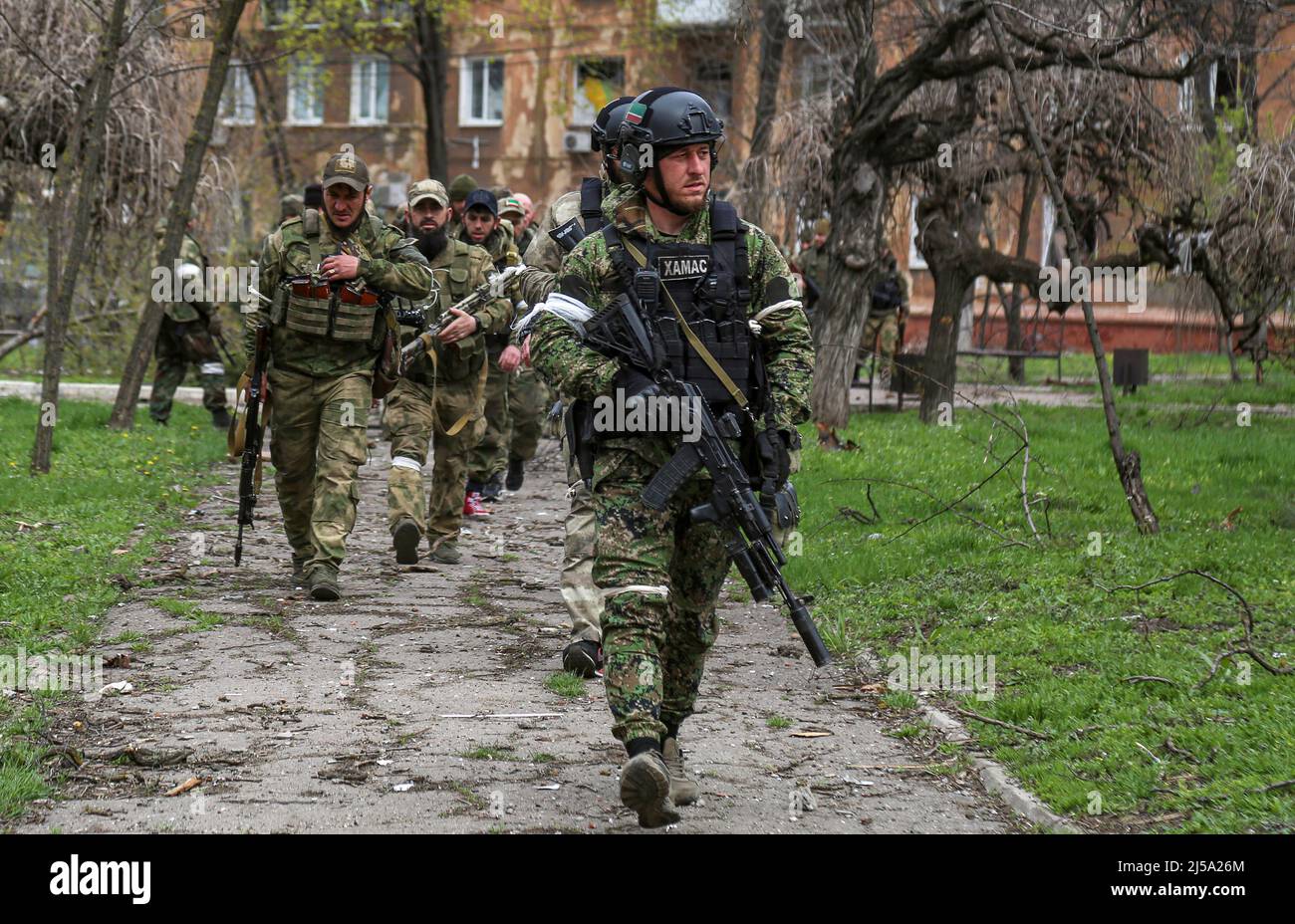 Fighters of the Chechen special forces unit walk in a courtyard during