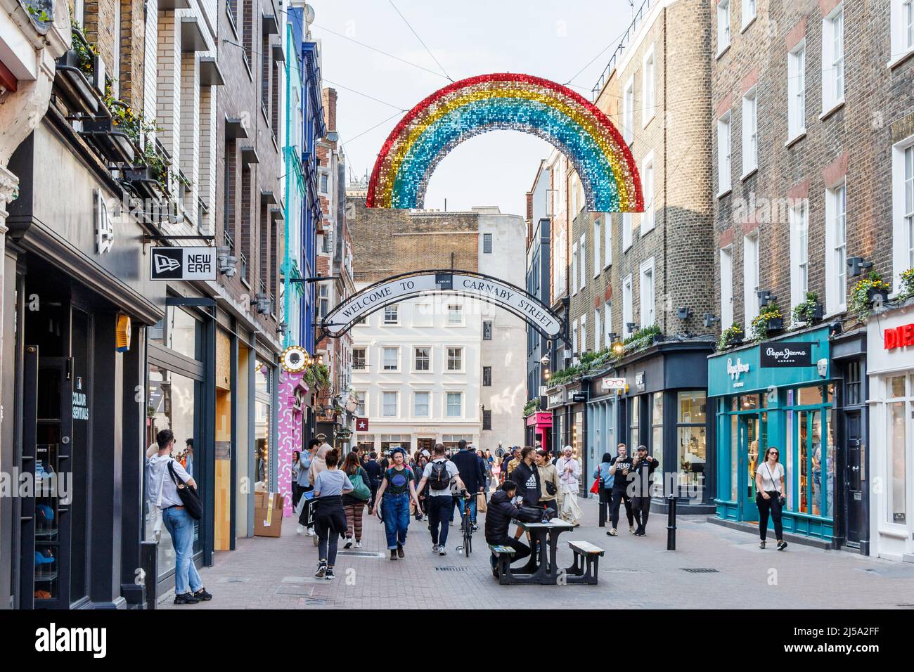 Shoppers and tourists in Carnaby Street, a pedestrianised area in Soho, home to fashion and lifestyle retailers and independent boutiques, London, UK Stock Photo