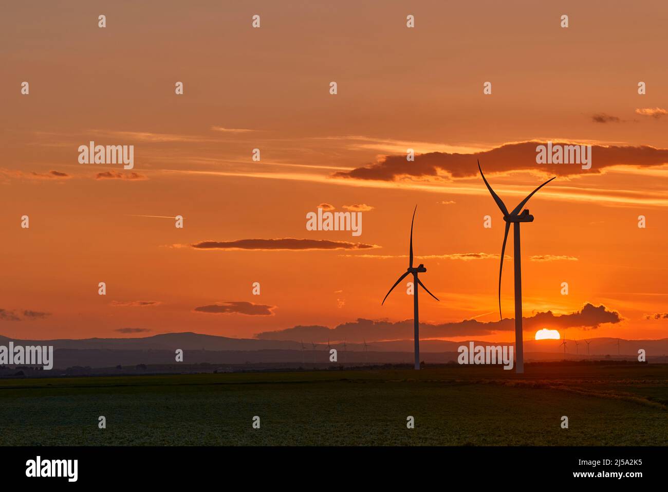 Wind turbines at sunset (Turbine eoliche al tramonto) Stock Photo