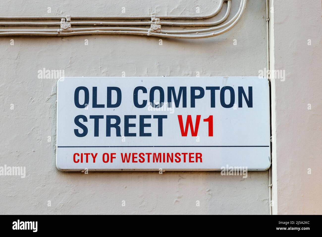 Street name sign on a wall in Old Compton Street, Soho, London, UK Stock Photo