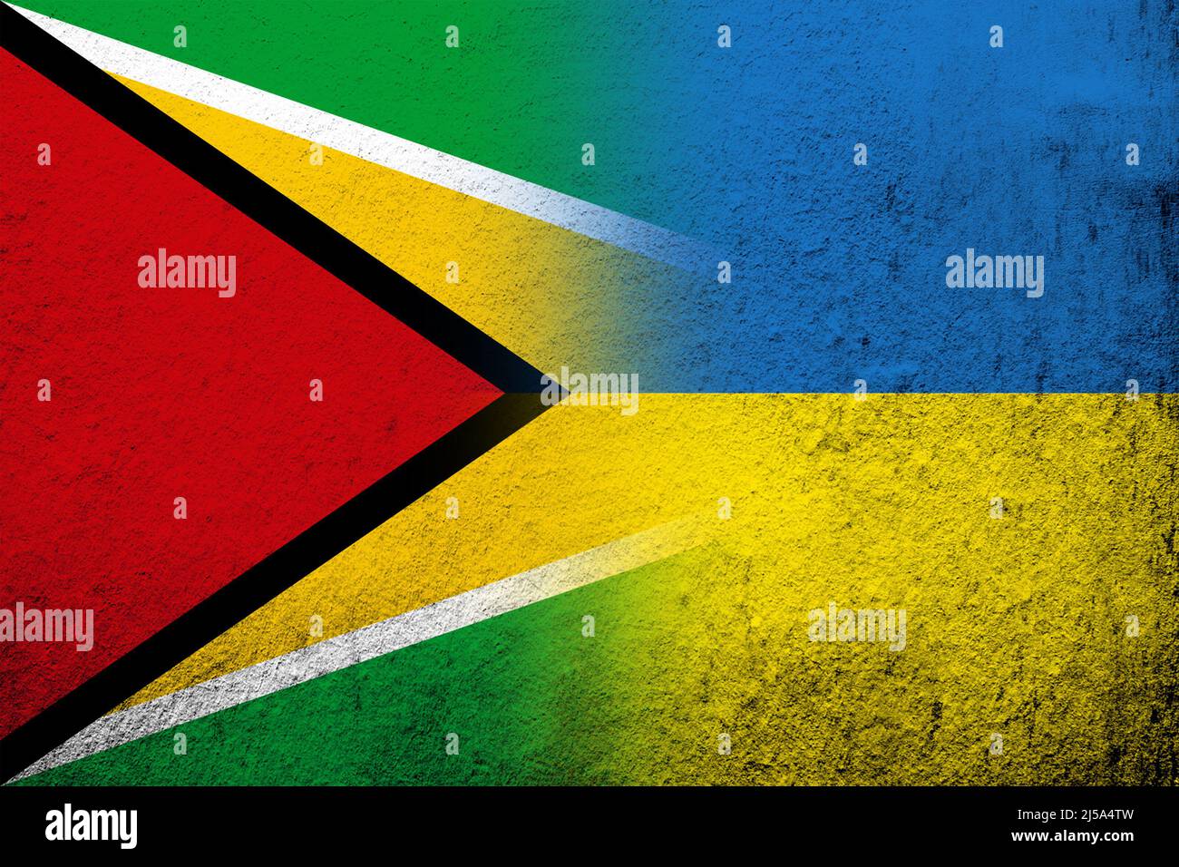 The Co-operative Republic of Guyana National flag with National flag of Ukraine. Grunge background Stock Photo