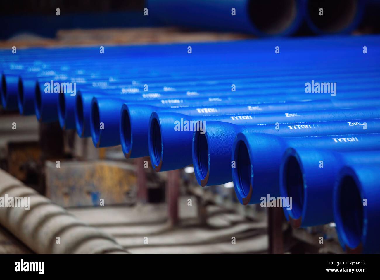 New cast iron pipes for pipeline construction in warehouse Stock Photo