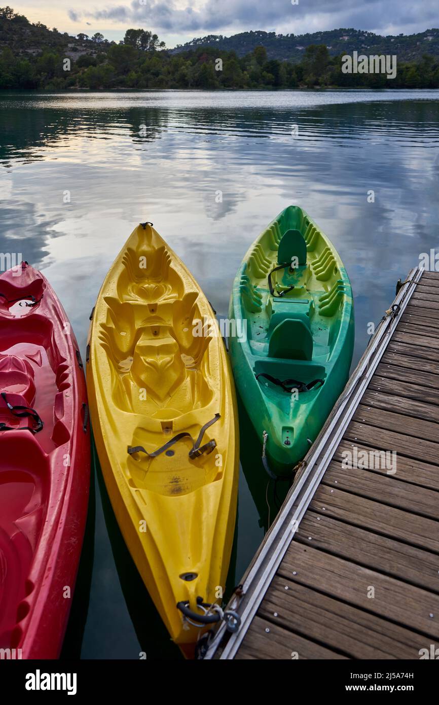 Three Kayaks at Sunset moored to a pontoon on the edge of Lac d