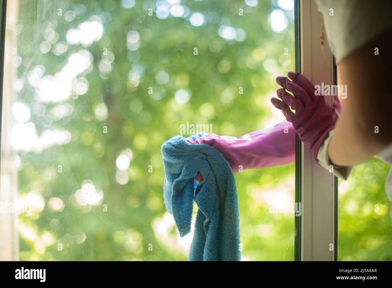 Washes the window with a rag. Cleaning windows from dirt. House ...