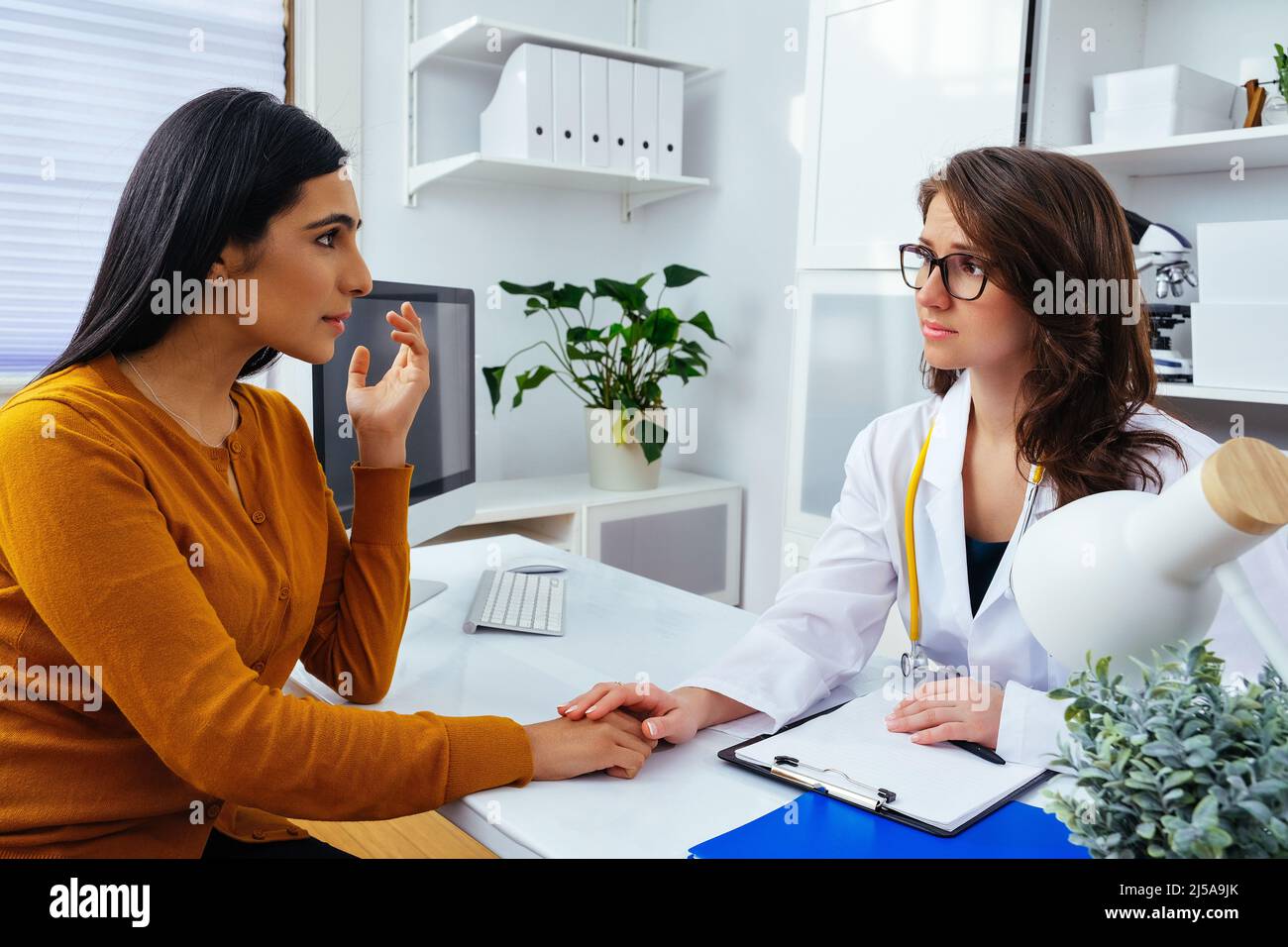 female doctor talking with her patient in hospital healthcare industry ...