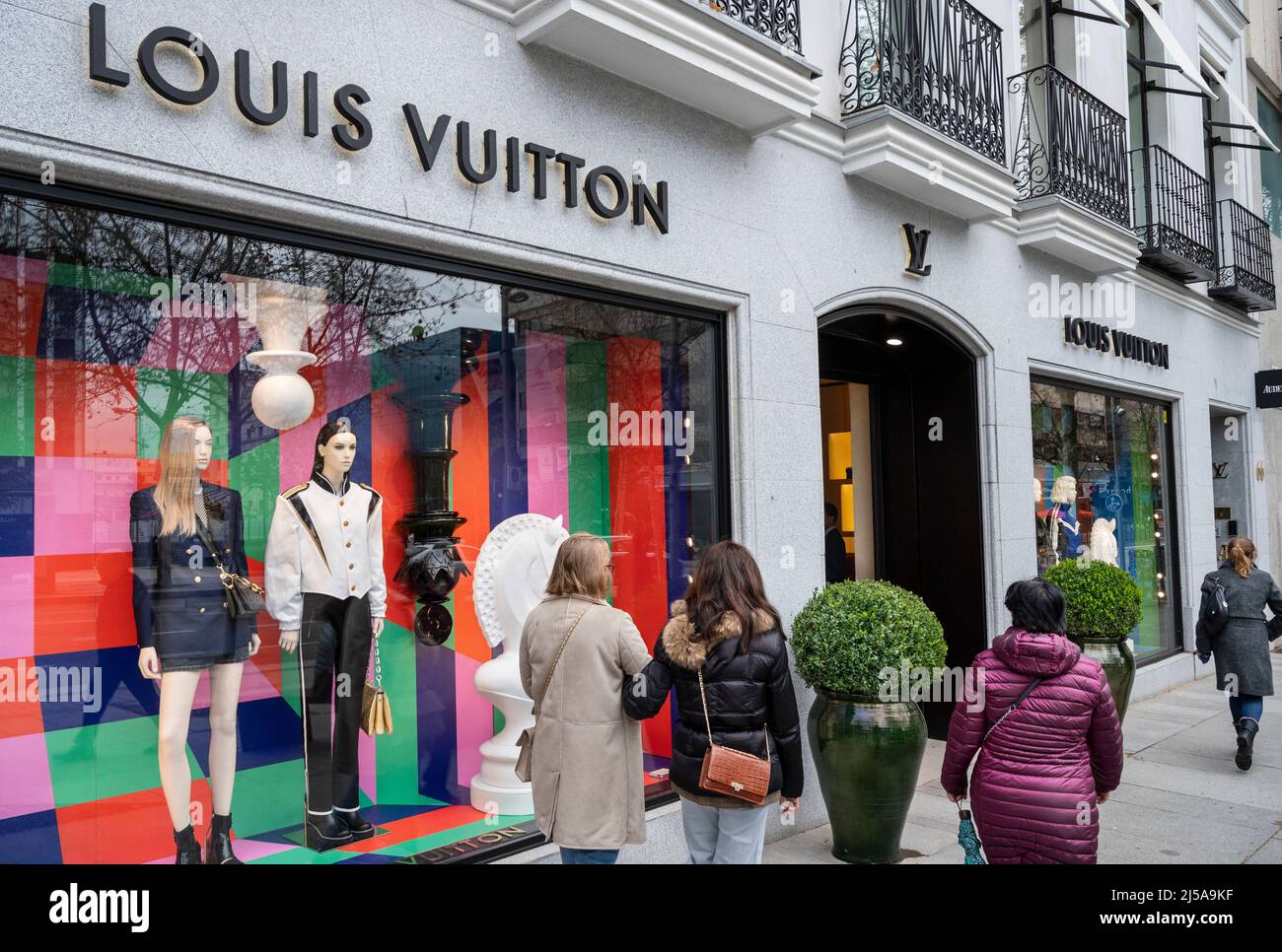 Madrid, Spain. 26th Mar, 2022. Pedestrians walk past the French luxury  fashion brand Louis Vuitton (LV)