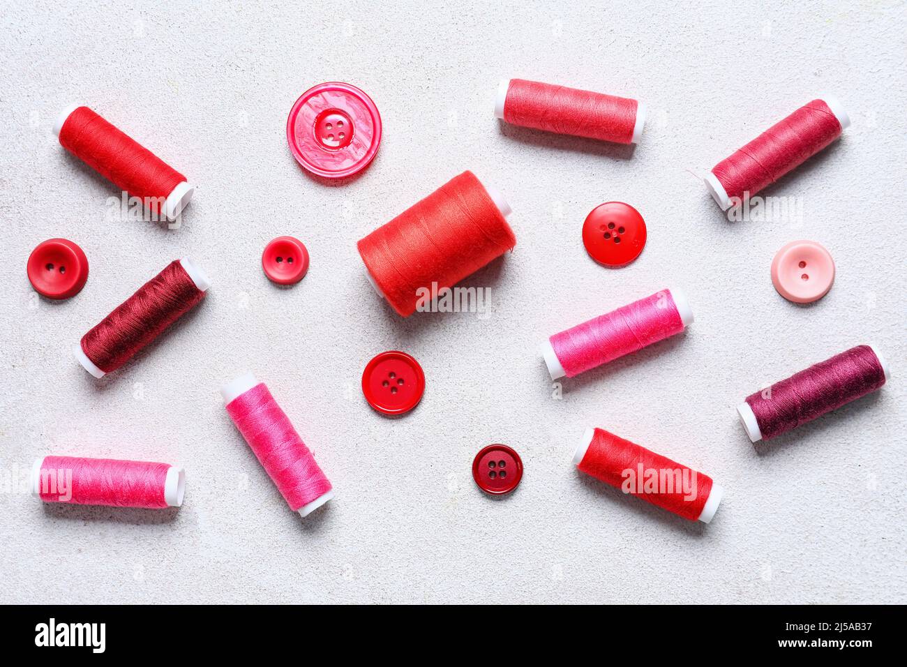 Sewing threads and buttons on light background Stock Photo - Alamy