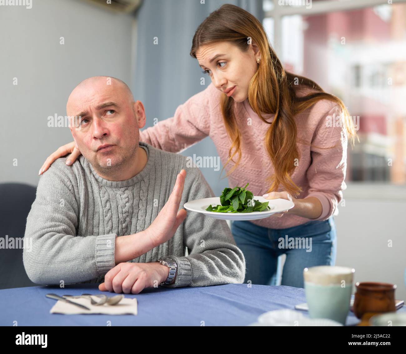 Man dissatisfied by dinner made by his wife Stock Photo