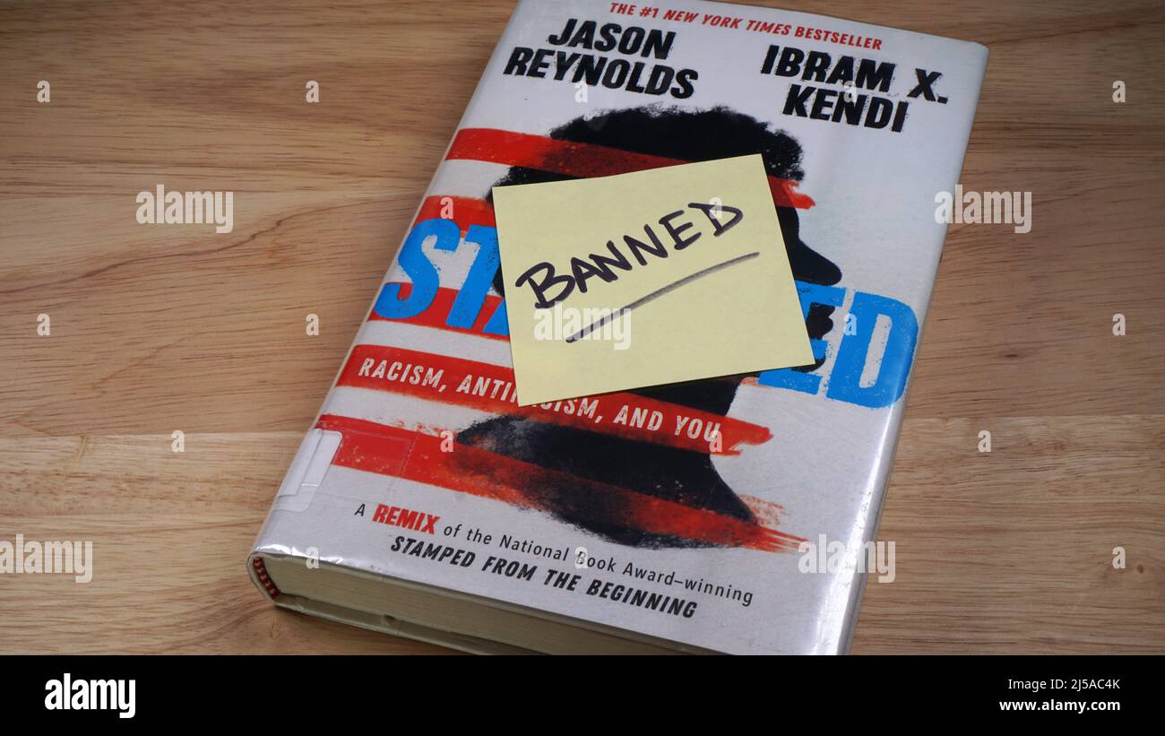 A copy of the book Stamped by Jason Reynolds and Ibram X Kendi. The book is found on many schools' banned book lists. Stock Photo