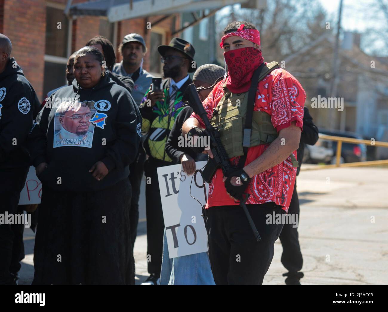 A man carries a weapon during a #Justice4Patrick rally for Patrick Lyoya, an unarmed Black man who was shot and killed by a Grand Rapids Police officer during a traffic stop on April 4th, in Lansing, Michigan, U.S., April 21, 2022.  REUTERS/Rebecca Cook Stock Photo