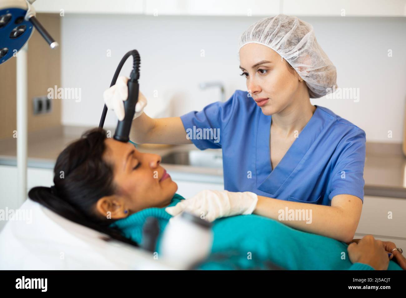 Woman receiving facial cleaning hi-res stock photography and images - Alamy