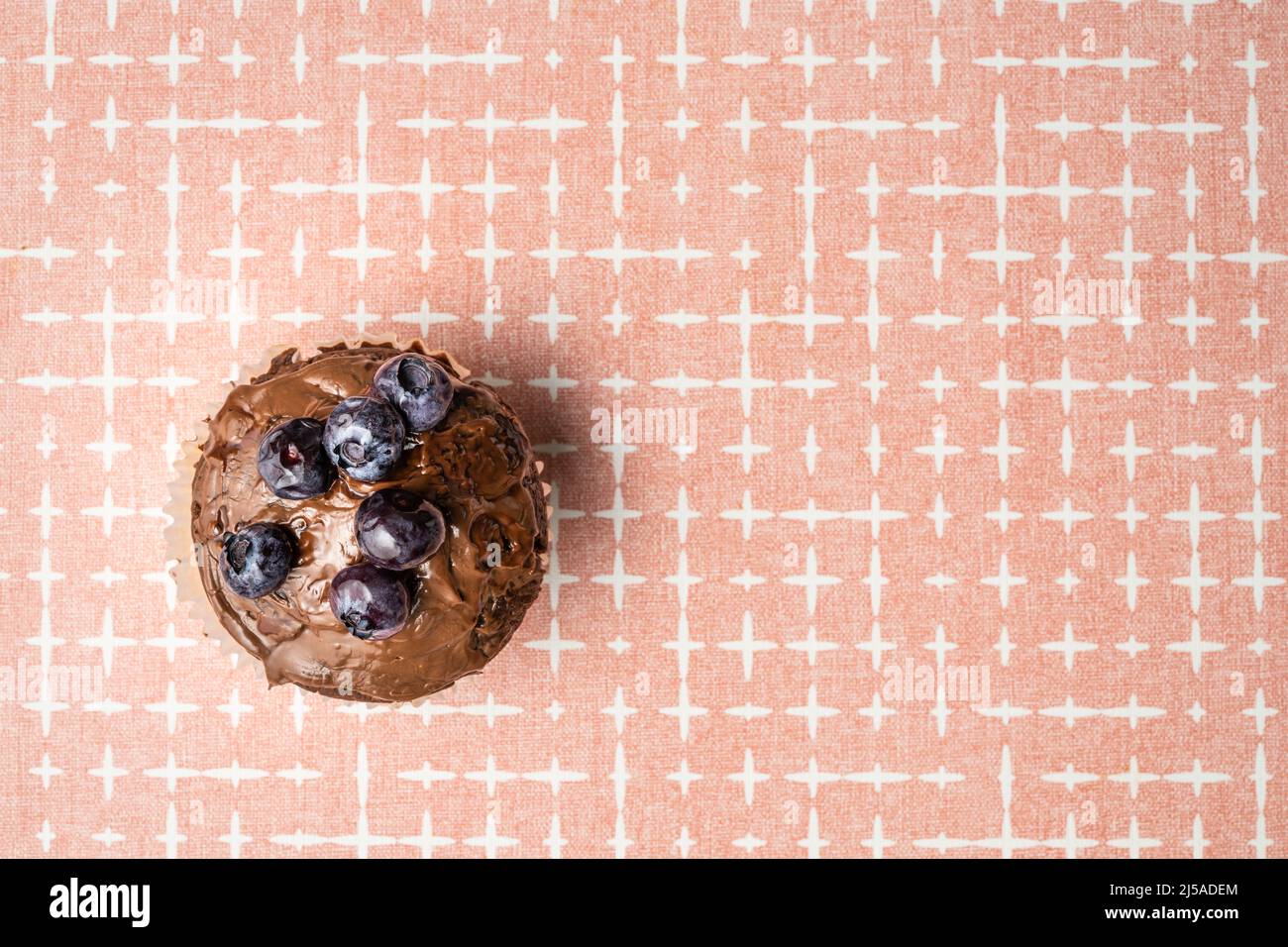 fresh baked muffin with chocolate cream and blueberries on the table copy space top view Stock Photo