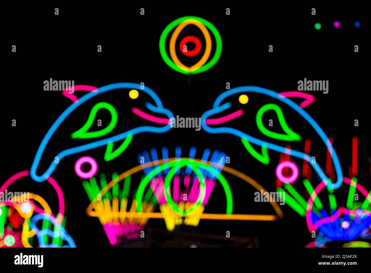 Blured Multi-colored neon lights at night. Stock Photo