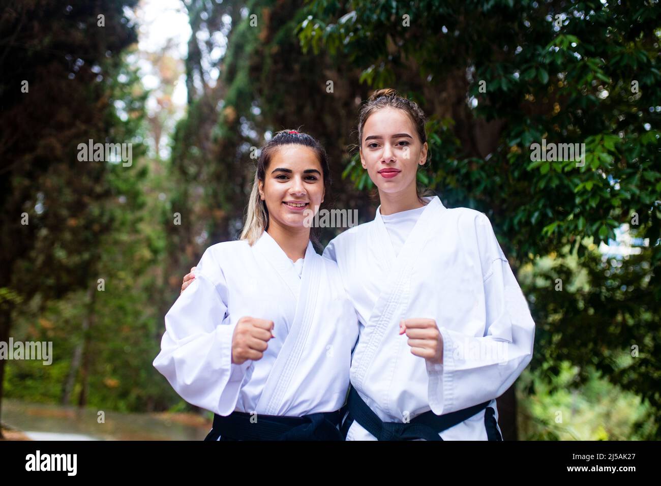 people high kicks during training of taekwondo outdoors bamboo