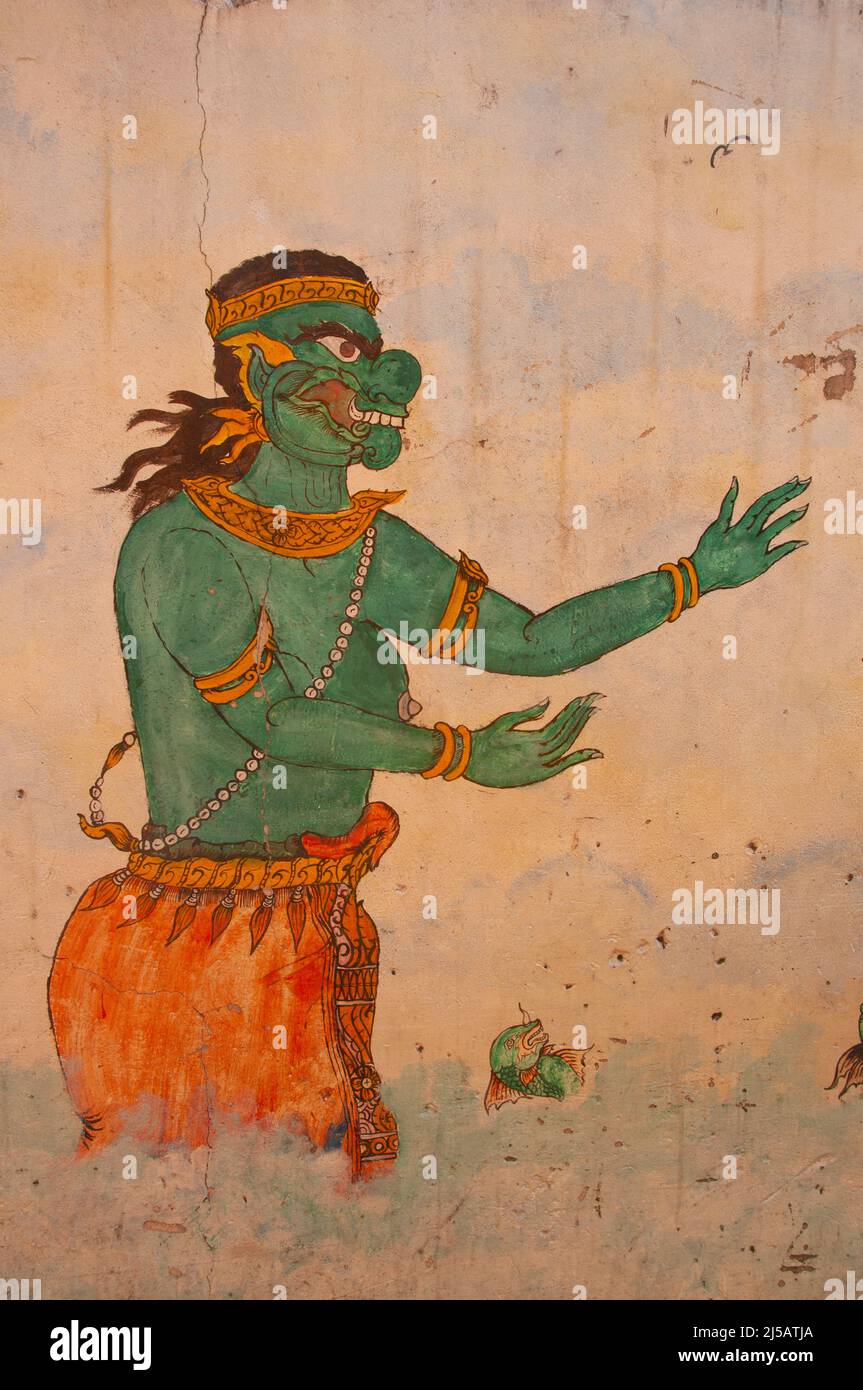 Thailand: A Yaksha or temple guardian, mural on a wall at the front of a guest house in Bangkok. In Buddhist mythology, the Yaksa (Yaksha or Yak) are the attendants of Vaiśravaṇa, the Guardian of the Northern Quarter, a beneficent god who protects the righteous. The term also refers to the Twelve Heavenly Generals who guard Bhaiṣajyaguru, the Medicine Buddha. Stock Photo