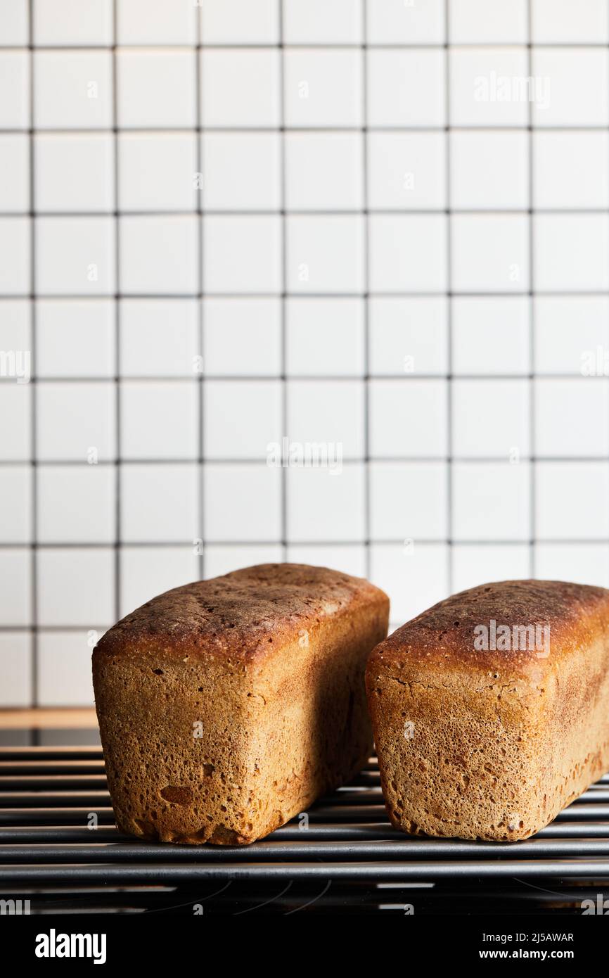 The process of making rye bread. The finished bread is taken out of the