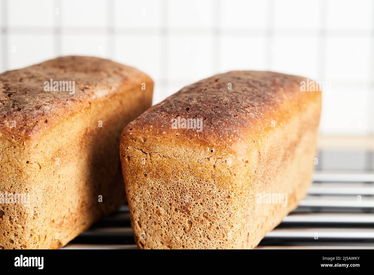 The process of making rye bread. The finished bread is taken out of the