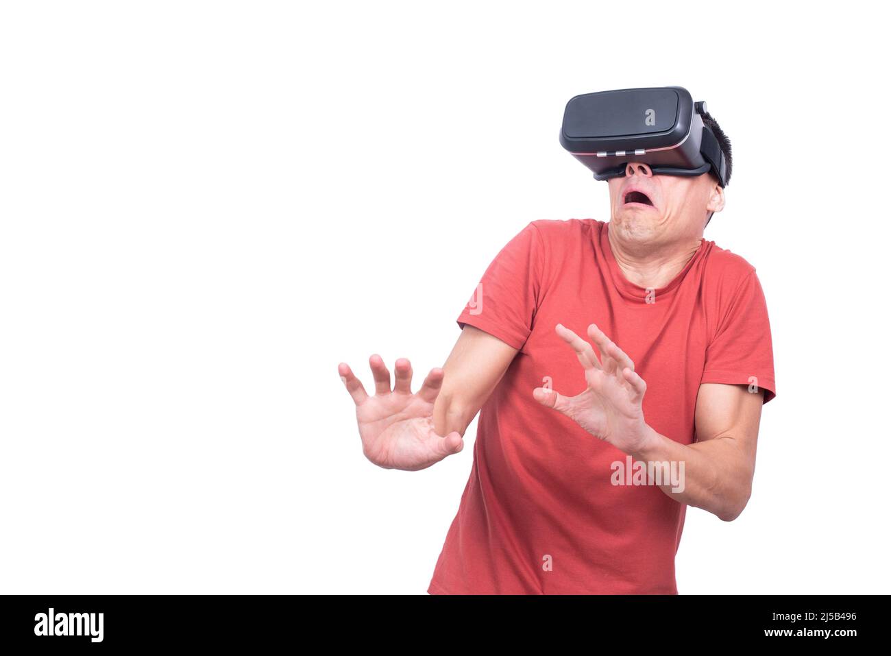 Scared man exploring virtual reality in studio Stock Photo
