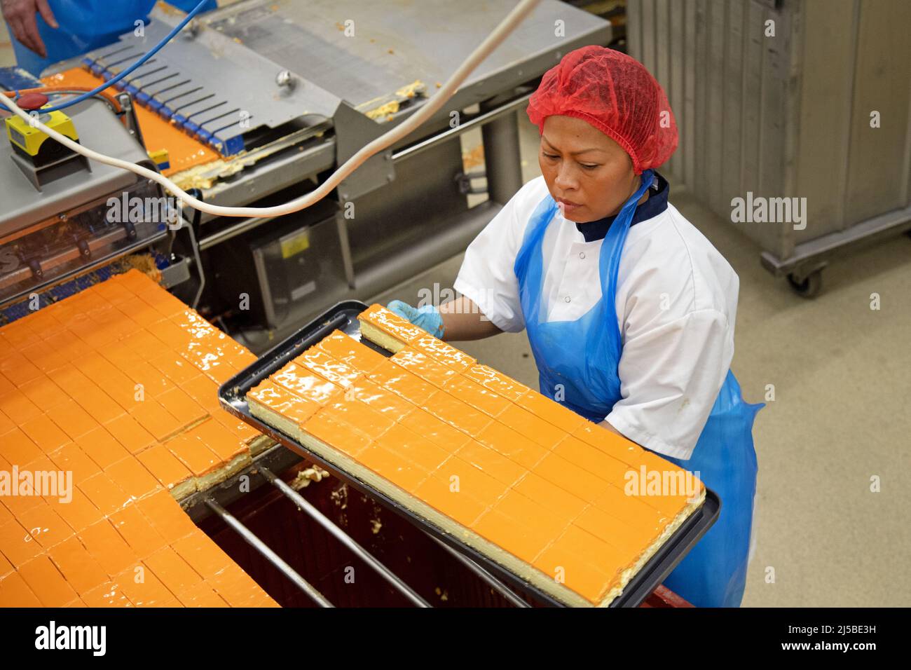 Almere, Netherlands. 22nd Apr, 2022. 2022-04-22 07:32:32 ALMERE - The HEMA bakery makes the very first orange tompouces for King's Day. ANP OLAF KRAAK netherlands out - belgium out Credit: ANP/Alamy Live News Stock Photo