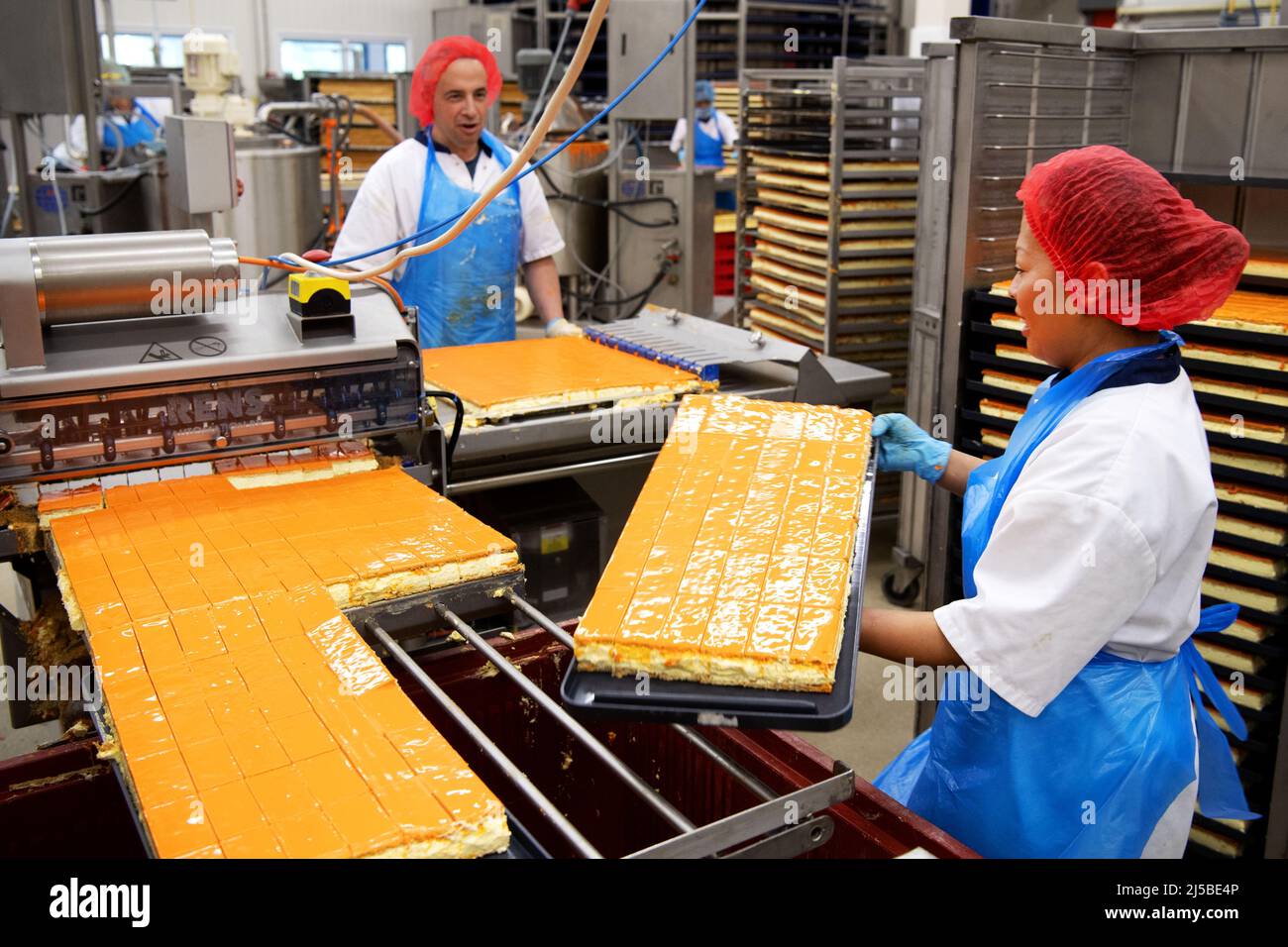 Almere, Netherlands. 22nd Apr, 2022. 2022-04-22 07:28:44 ALMERE - The HEMA bakery makes the very first orange tompouces for King's Day. ANP OLAF KRAAK netherlands out - belgium out Credit: ANP/Alamy Live News Stock Photo