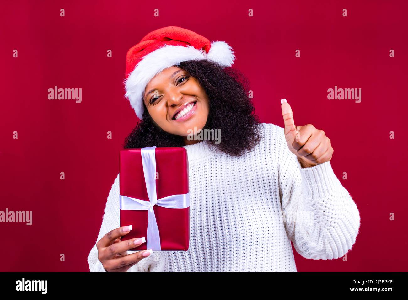 joyful pretty woman in red santa claus hat laughing isolated on red ...