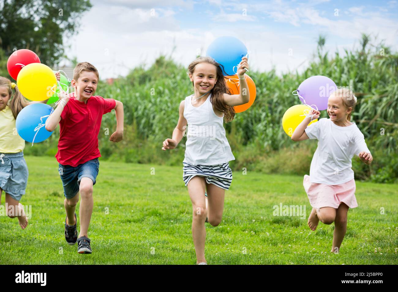 children running with air balloons in park Stock Photo - Alamy