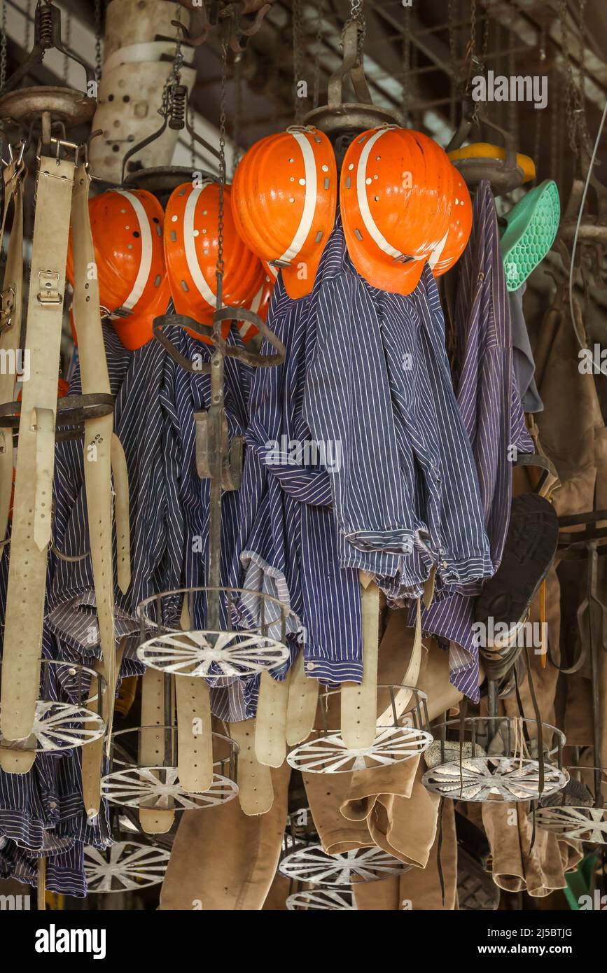 Dortmund, North Rhine-Westphalia, Germany - LWL Industrial Museum Zollern Colliery. In the former washhouse, miners' clothing hangs in baskets under t Stock Photo